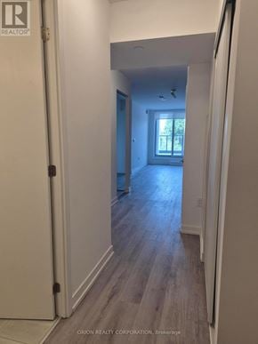 Toronto (Yorkdale-Glen Park) condo for rent - A hallway with wood floors and white walls.