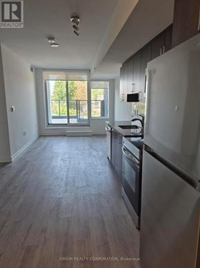 Toronto (Yorkdale-Glen Park) condo for rent - A kitchen with a refrigerator, oven, and sink.
