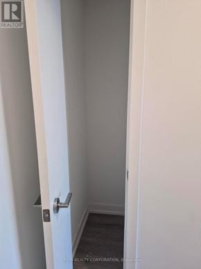 Toronto (Yorkdale-Glen Park) condo for rent - A hallway with a door on the left and a wall on the right.