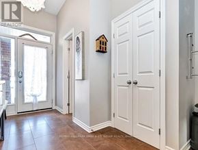 Ottawa townhouse for rent - A hallway with white doors and a chandelier.