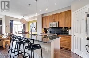 Ottawa townhouse for rent - A kitchen with a black counter top and wooden cabinets.