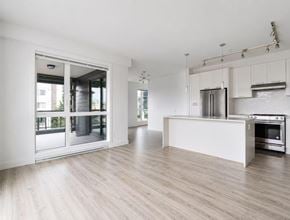 Langley apartment for rent - A modern kitchen with a wooden floor and white walls.