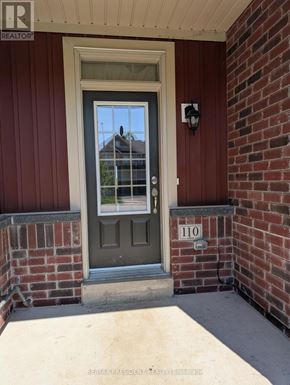 Grey Highlands townhouse for rent - A green door with a glass window is on the front of a house.