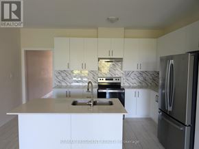 Grey Highlands townhouse for rent - A kitchen with white cabinets and a marble backsplash.