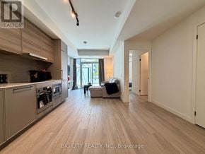 Toronto (The Beaches) condo for rent - A spacious kitchen with modern appliances and a large island.