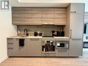 Toronto (The Beaches) condo for rent - A modern kitchen with a large island and built-in appliances.