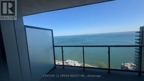 Burlington (Brant) condo for rent - A balcony with a view of the ocean and buildings.