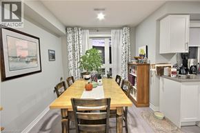 Kitchener townhouse for rent - A dining room with a wooden table and chairs.