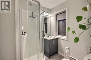 Kitchener townhouse for rent - A bathroom with a glass shower door and a window.