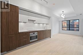 Toronto (Thorncliffe Park) condo for rent - A modern kitchen with wooden cabinets and stainless steel appliances.