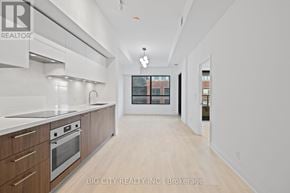 Toronto (Thorncliffe Park) condo for rent - A modern kitchen with wooden cabinets and stainless steel appliances.