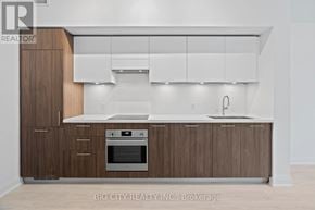 Toronto (Thorncliffe Park) condo for rent - A modern kitchen with wooden cabinets and a white countertop.