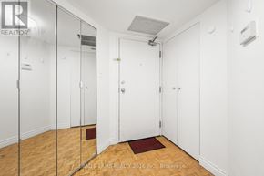 Toronto (Bay Street Corridor) condo for rent - A hallway with white walls and wooden floors.