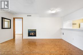 Toronto (Bay Street Corridor) condo for rent - A room with a fireplace and a wooden floor.