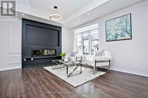 Pickering (Duffin Heights) townhouse for rent - A living room with a dark wood floor and a white couch.
