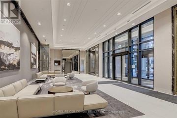 Markham (Unionville) condo for rent - A spacious living room with a white sofa set and a large painting on the wall.