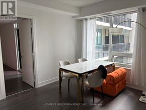 Markham (Unionville) condo for rent - A dining room with a table and chairs and a view of a balcony.