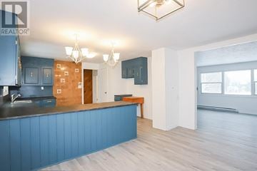 Richards Landing apartment for rent - A kitchen with blue cabinets and a wooden island.