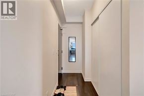 Kitchener condo for rent - A hallway with a window and a door.