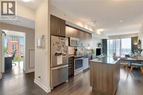 Kitchener condo for rent - A modern kitchen with wooden floors and stainless steel appliances.