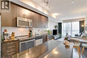 Kitchener condo for rent - A modern kitchen with wooden cabinets and stainless steel appliances.