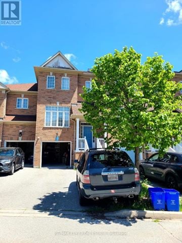 Ajax (Central West) townhouse for rent - A house with a car parked in front of it.