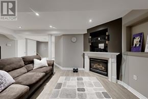 Barrie (Painswick South) apartment for rent - A living room with a fireplace and a couch.