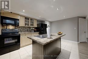 Barrie (Painswick South) apartment for rent - A modern kitchen with a granite countertop and stainless steel appliances.