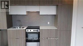Toronto (Church-Yonge Corridor) condo for rent - A kitchen with a stove, sink, and cabinets.