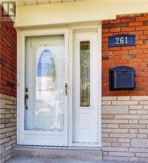 Toronto (Willowdale West) apartment for rent - A white door with a glass window is on the front of a brick house.