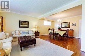 Toronto (Willowdale West) apartment for rent - A living room with a brown ottoman and a white couch.