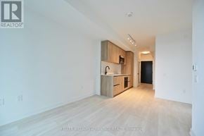 Toronto (Mount Pleasant West) condo for rent - A spacious, empty room with a kitchenette in the corner.