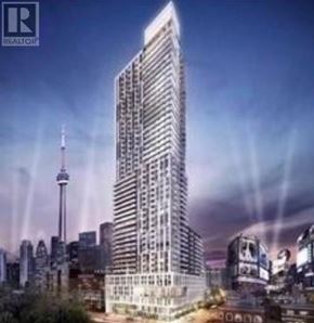 Toronto (Church-Yonge Corridor) condo for rent - A tall building with many windows is the main focus of this image.