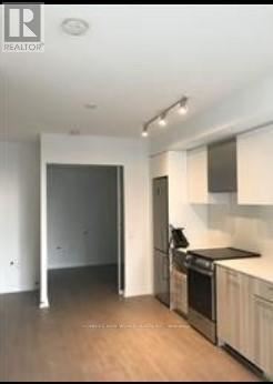 Toronto (Church-Yonge Corridor) condo for rent - A kitchen with a stove top oven and a refrigerator.