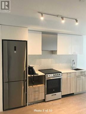 Toronto (Church-Yonge Corridor) condo for rent - A modern kitchen with a stainless steel refrigerator and oven.