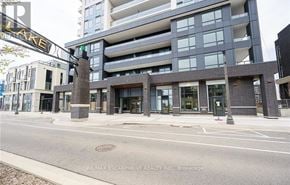 Grimsby (Grimsby Beach) condo for rent - A modern building with a glass facade and a street in front.
