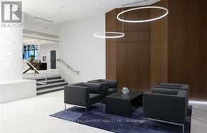 Grimsby (Grimsby Beach) condo for rent - A modern living room with a staircase and a large window.