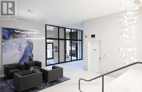 Grimsby (Grimsby Beach) condo for rent - A modern office lobby with a glass wall and a reception desk.