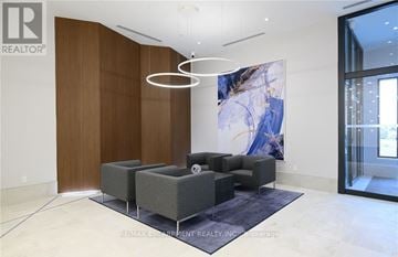 Grimsby (Grimsby Beach) condo for rent - A modern living room with a grey sofa set and a large abstract painting on the wall.