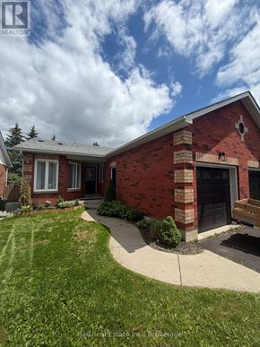 Peterborough (Monaghan Ward 2) townhouse for rent - A red brick house with a black door and a small porch.