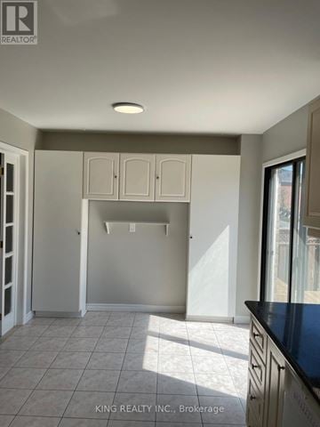 Markham (Middlefield) apartment for rent - A kitchen with white cabinets and a black countertop.