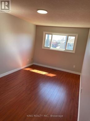 Markham (Middlefield) apartment for rent - A room with a window and wooden flooring.