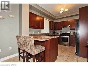 Ancaster townhouse for rent - A kitchen with a refrigerator, oven, and sink.