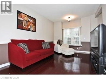 Ancaster townhouse for rent - A living room with a red couch and a television.