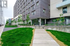 Peterborough (Ashburnham Ward 4) condo for rent - A modern building with a green lawn in front.