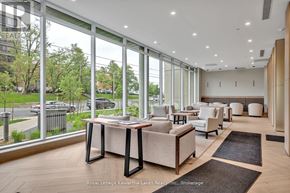 Peterborough (Ashburnham Ward 4) condo for rent - A spacious living room with a view of the street outside the large windows.