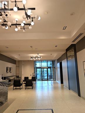 Mississauga (Hurontario) condo for rent - A large, well-lit lobby with a reception desk and chairs.