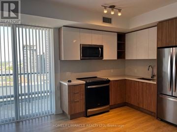 Toronto (Mount Pleasant East) condo for rent - A kitchen with wooden cabinets and stainless steel appliances.