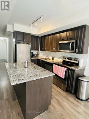Toronto (Rouge) townhouse for rent - A kitchen with a granite countertop and stainless steel appliances.