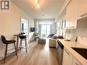 Grimsby condo for rent - A well-lit kitchen with a dining table and chairs.